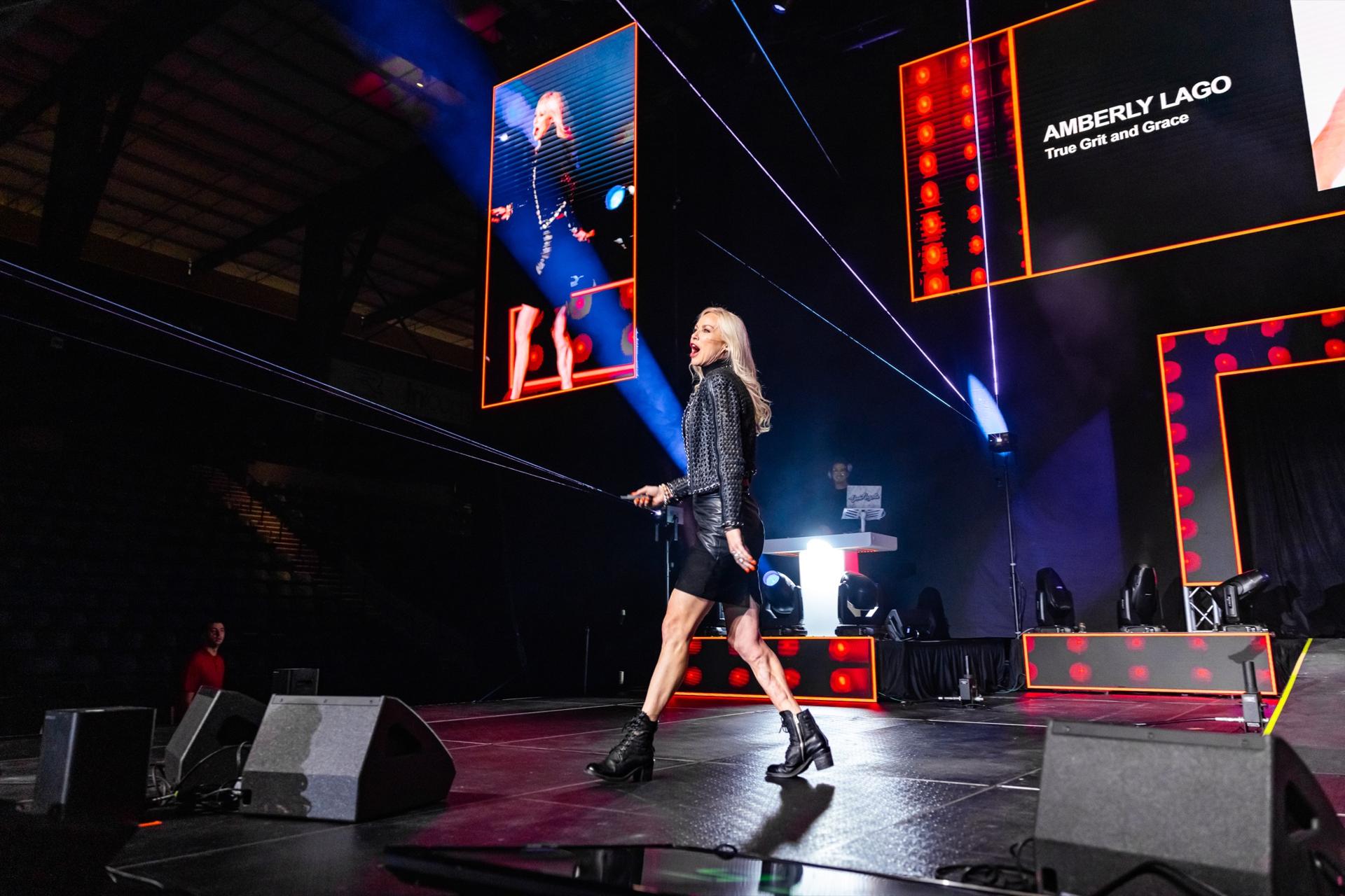 Amberly Lago on stage at an arena keynote